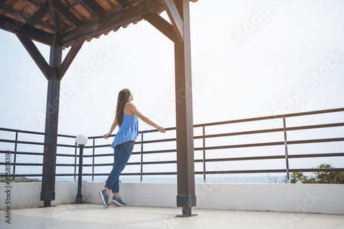 Peace and relaxation. Serene young woman is enjoying sea view while standing near the border
