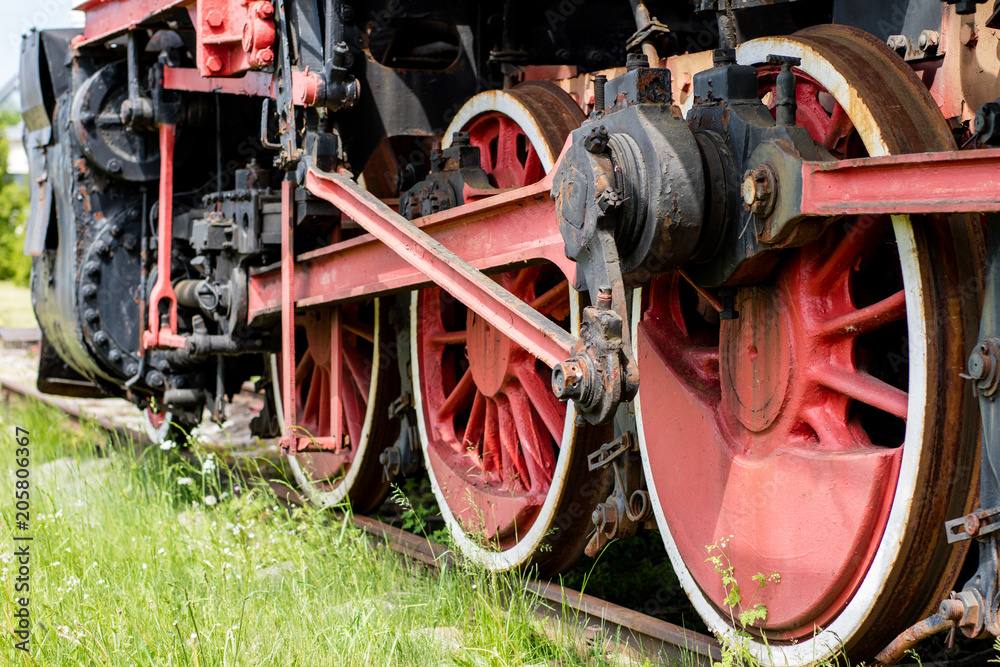 Chassis of the old train. Steel heavy wheels of a steam locomotive.