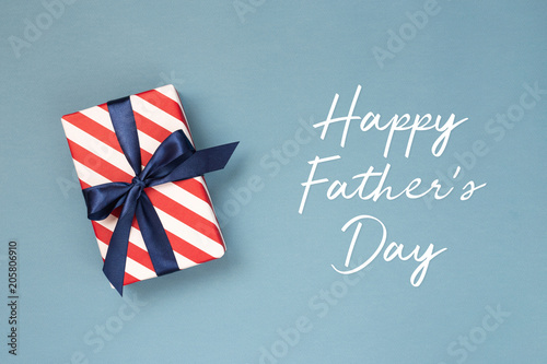 Happy Father's day greeting card with decorated gift box on blue background. ...