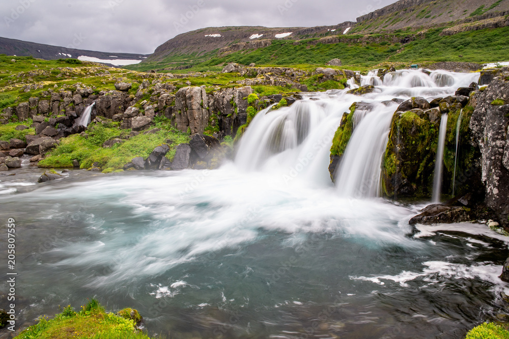 Baejarfoss waterfall under more famous Dynjandi fall in Iceland, Europe taken with long exposure making a motion blur effect