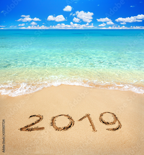 2019 written on sandy beach