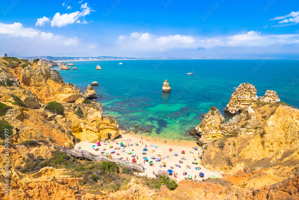 Fototapeta premium Lagos, Portugal - June, 09, 2015 - Enjoying a wonderful sunny day on the beach. Located in Algarve, Camilo Beach is one of the most famous and beautiful beaches in this area.
