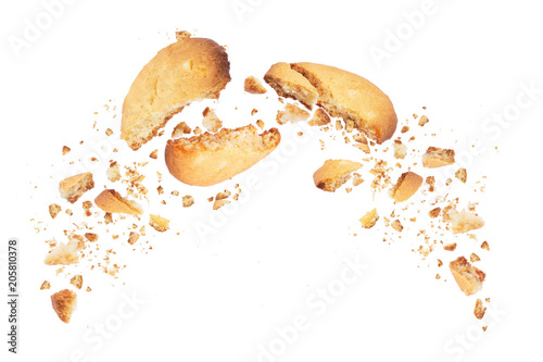 Fotografie Biscuits broken into two halves with falling crumbs down, isolated on white back