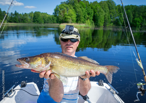 Happy angler with walleye fish