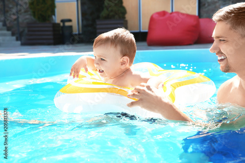 Child swimming lesson. Cute...