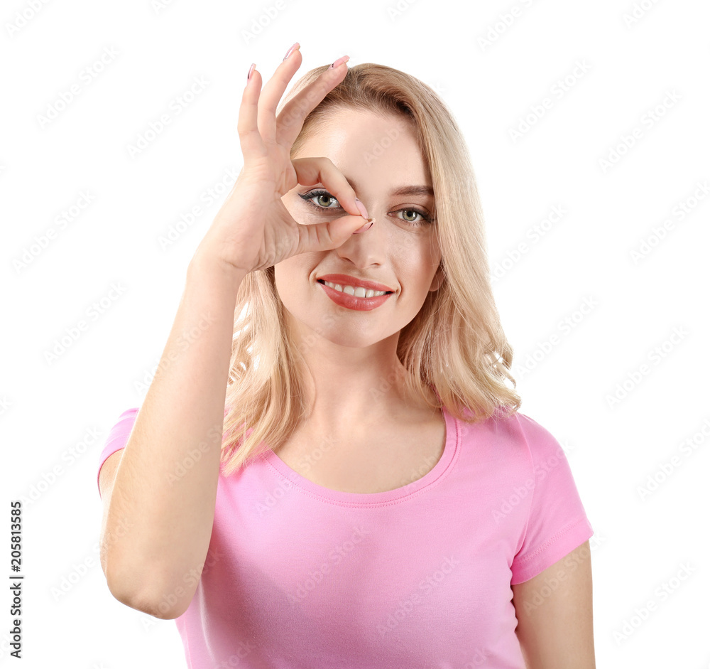 Young beautiful smiling woman showing OK gesture on white background Young beautiful smiling woman showing OK gesture on white background