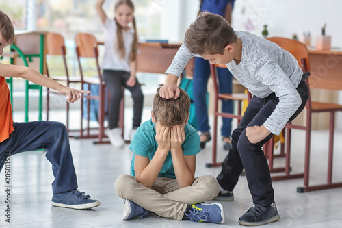 Children bullying their classmate in school photo