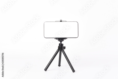 Photography Mobile phone set on tripod for taking pictures,white isolated background