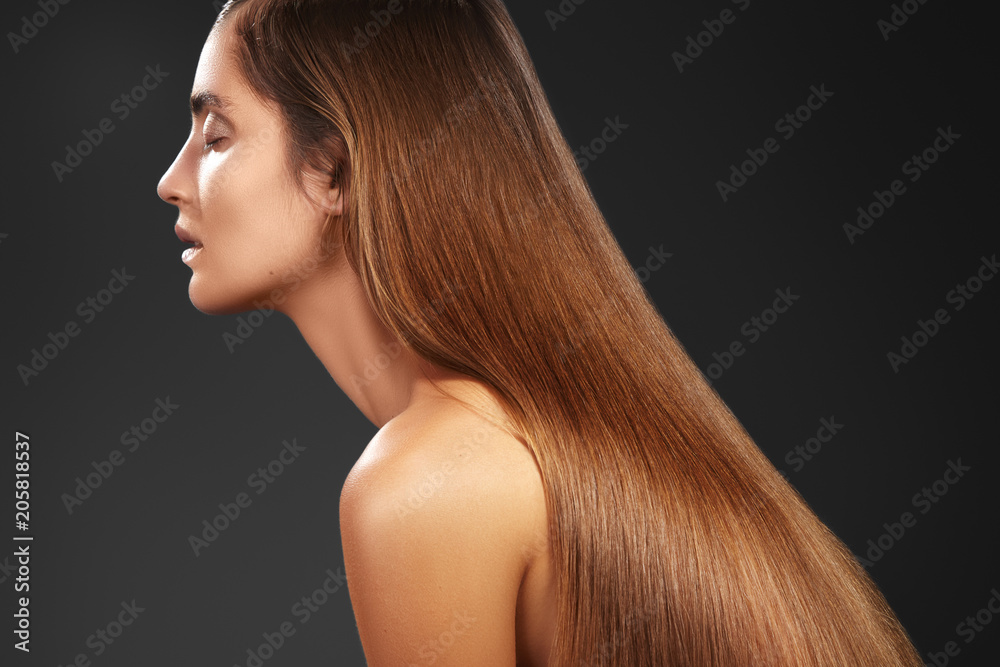 Naklejka premium Beautiful yong woman with long straight brown hair. Sexy fashion model with smooth gloss hairstyle. Keratine Treatment