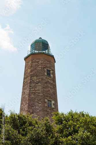 The upper half of the Old Cape Henry Lighthouse on a sunny summer day. Built in 1792, it is located on the Fort Story military base.