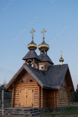 old wooden traditional church with golden kross