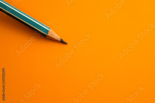blue pencil on a yellow orange background ,creative innovation idea symbol concept