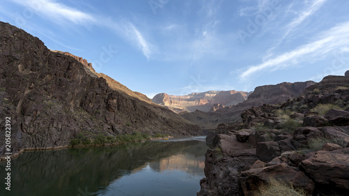 Campsite at dawn. Colorado River runs through Grand Canyon providing exciting whitewater rafting and incredible views along the way. Numerous side canyons can be hiked, often to beautiful waterfalls.