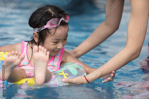 Asian Little Chinese Girl Playing in Swimming Pool