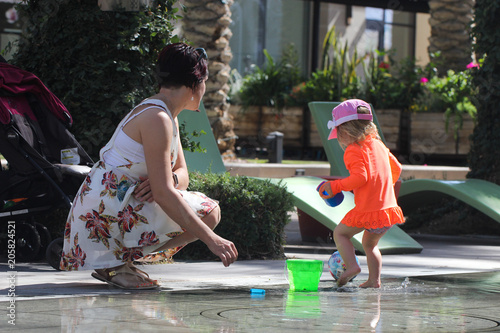 Close up Portrait of Beautiful Mother and 2 Years Old Blonde Toddler Girl in Pink Summer Hat, mother playing with baby Girl, Happy Family Concept, Having Fun in Scottsdale Arizona USA