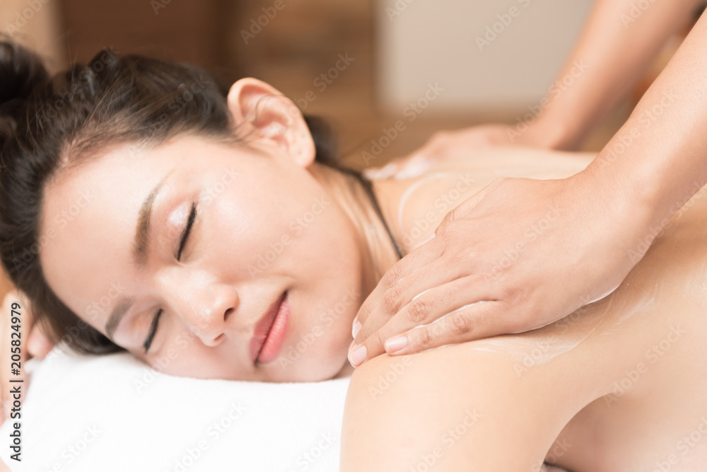 Young woman receiving salt massage in spa salon Young woman receiving salt massage in spa salon