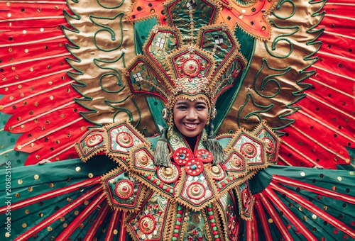 Photography Woman in traditional Indonesian costume of Garuda during ritual dance ceremony