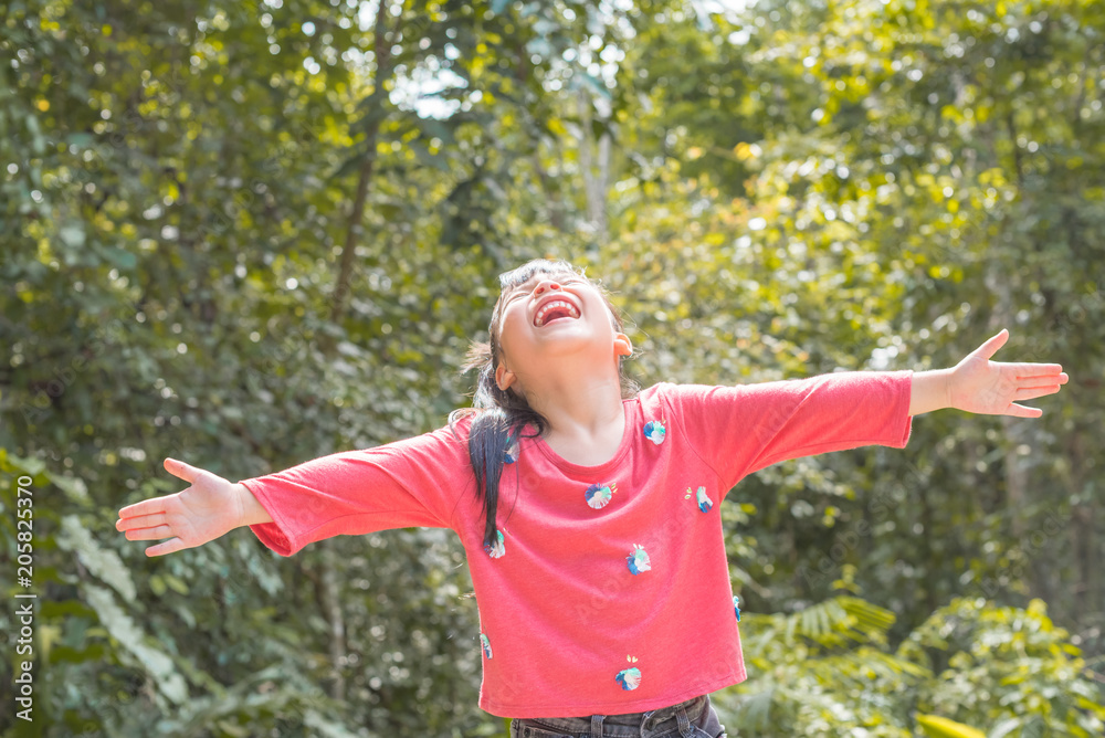 Happy child relaxing outdoors in spring filed