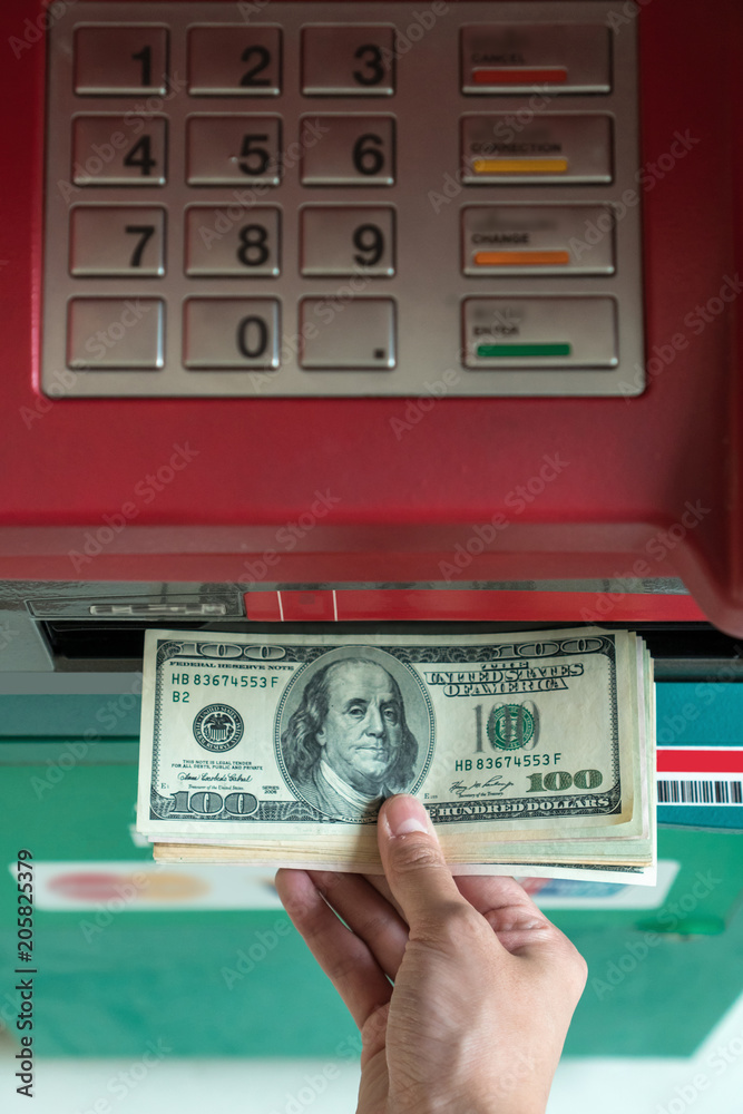 Top view of Closeup woman withdrawing the cash via ATM, business Automatic Teller Machine concept Top view of Closeup woman withdrawing the cash via ATM, business Automatic Teller Machine concept