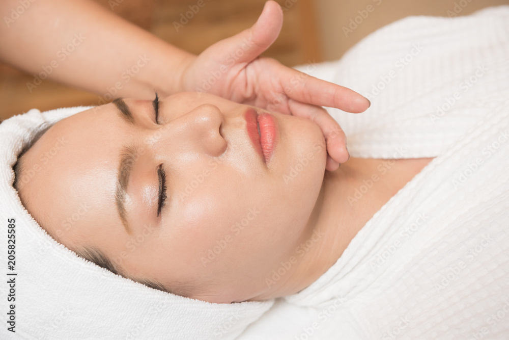 Face massage. Spa skin and body care. Close-up of young woman getting spa massage treatment at beauty spa salon. Facial beauty treatment. Face massage. Spa skin and body care. Close-up of young woman getting spa massage treatment at beauty spa salon. Facial beauty treatment.