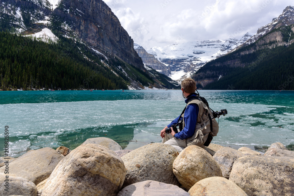 Travel male looking at mountain Lake Louise scenery, Banff National Park