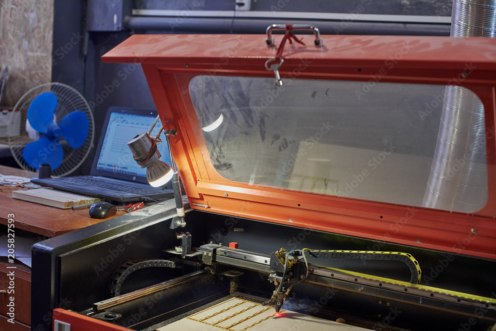 Naklejka premium Closeup of dusty laser machine and operator's working place