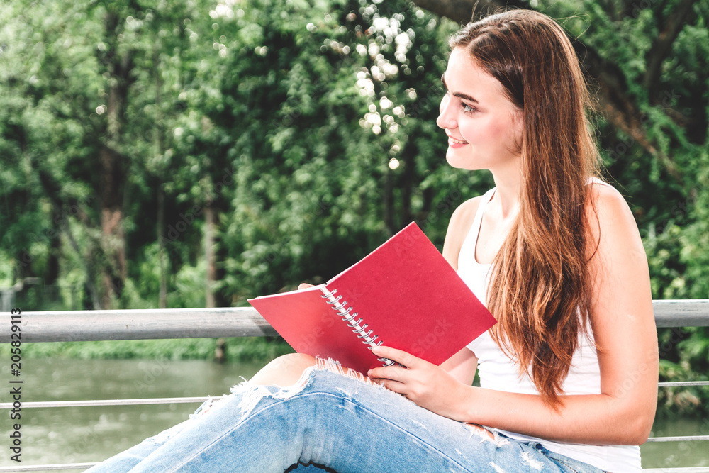 Obraz premium Woman students reading notebooks outdoors.Education concept