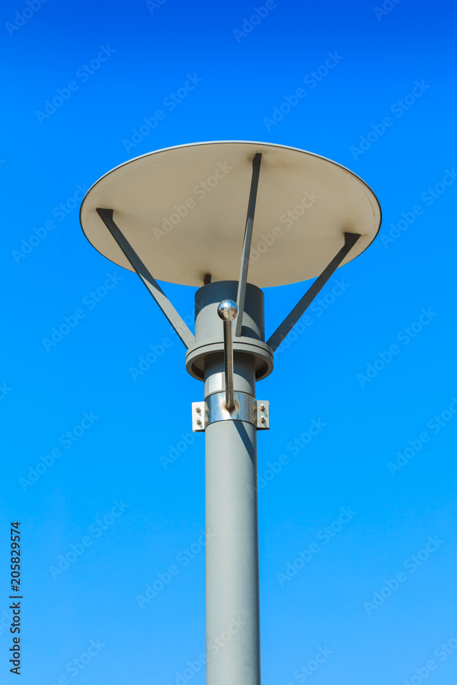 Isolated street light with sign pole on blue sky background