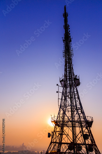 Shadow image of Landmark in Korea, N-Seoul tower on blue sky background with sparkling orange light in twilight time