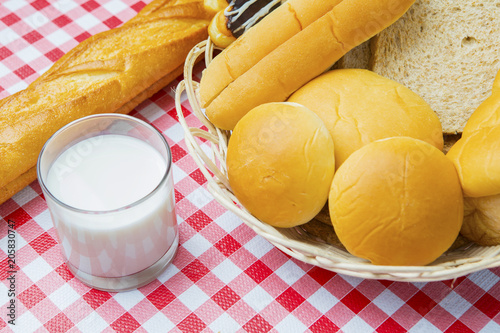Fototapeta Naklejka Na Ścianę i Meble -  Assorted fresh breads with milk on the table