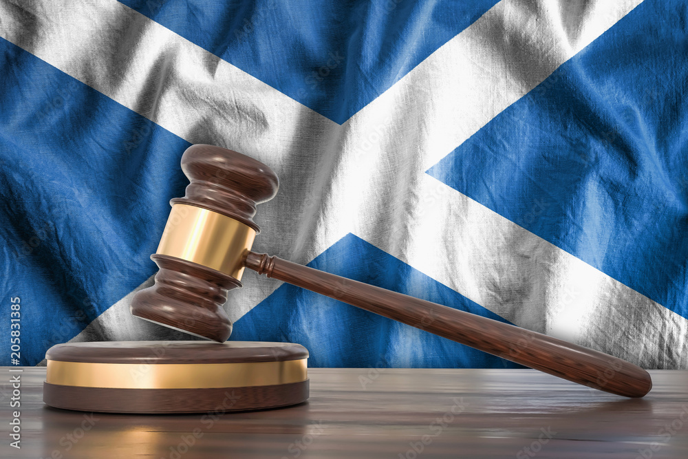 Wooden gavel and flag of Scotland on background - law concept