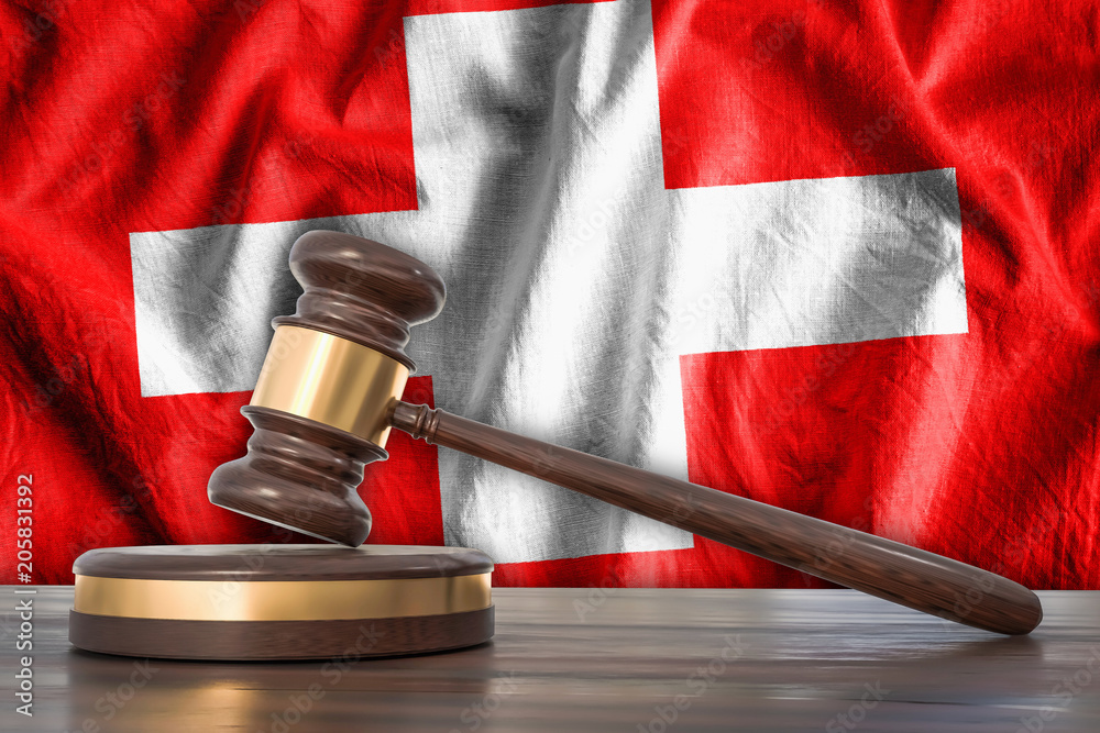 Wooden gavel and flag of Switzerland on background - law concept