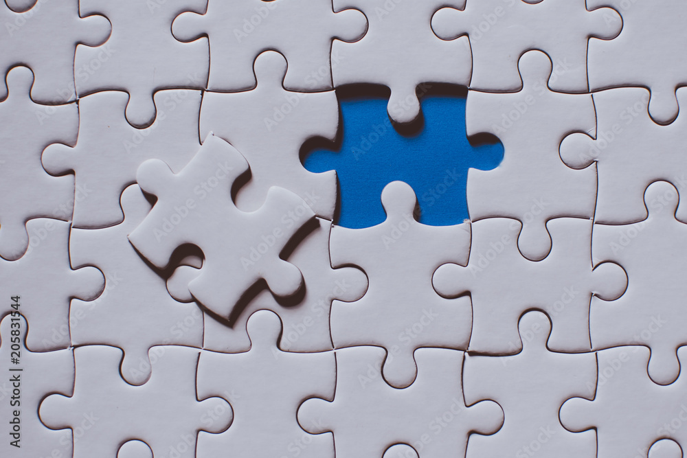 Jigsaw with one piece missing revealing Jigsaw with one piece missing revealing