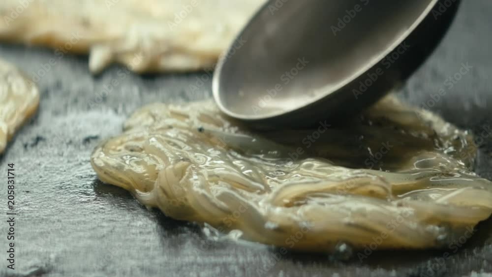 Extreme close up raw whitebait placed onto hot stove Extreme close up raw whitebait placed onto hot stove