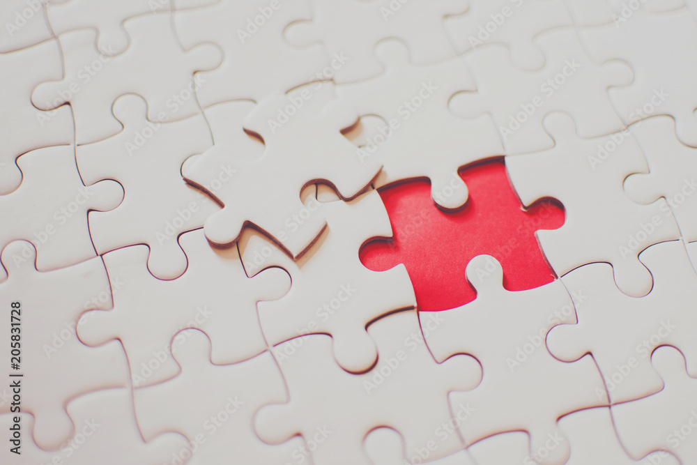 Jigsaw with one piece missing revealing Jigsaw with one piece missing revealing