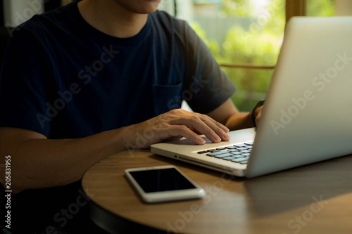 Close up hands man using laptop .