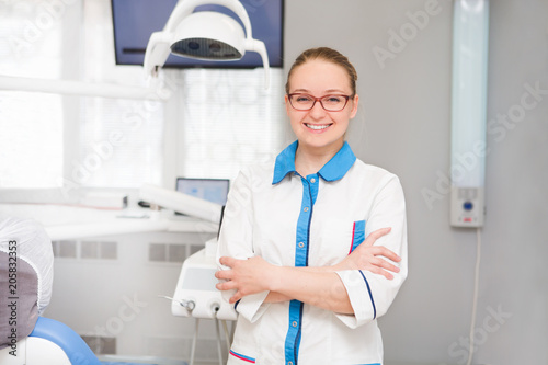 Portrait of female dentist with tools  in her dentist office and looking at camera. Medicine  stomatology  healthcare concept.