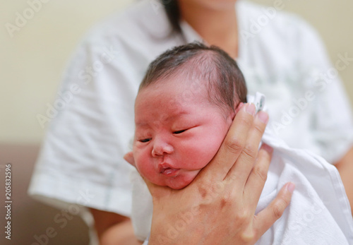 Foto Health care after meal. Mother is belching for infant baby.