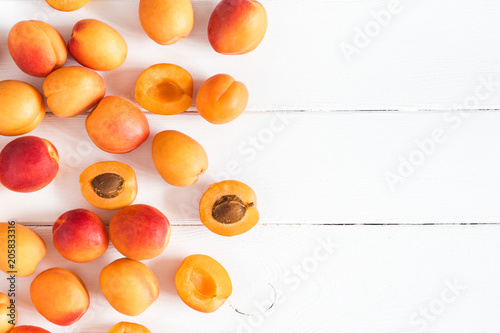 Apricots on white wooden background. Flat lay, top view, copy space