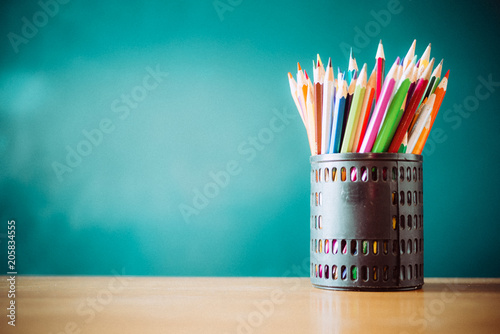 pencil box on the desk in front of blackboard
