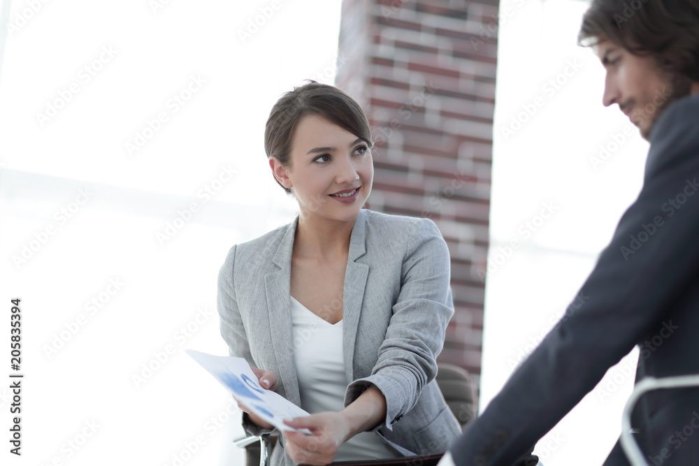 A relaxed conversation of a man and a woman in the office A relaxed conversation of a man and a woman in the office