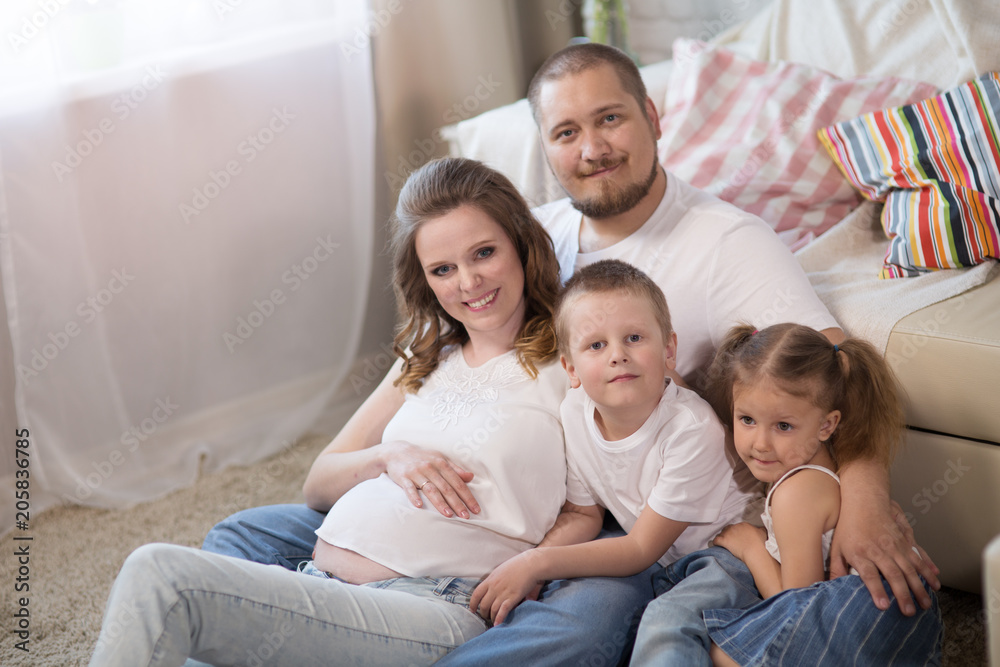 Family with children and a pregnant mother