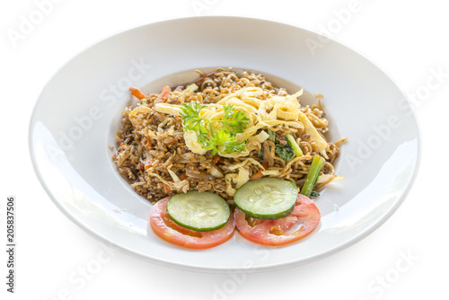 Fried rice nasi goreng with chicken and vegetables on a plate. Indonesian cuisine.