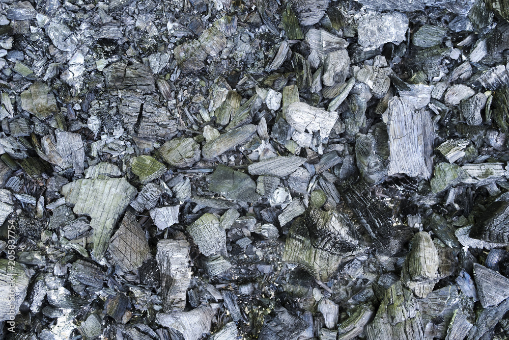 Texture of black coal is firewood burned in the fire, as a background