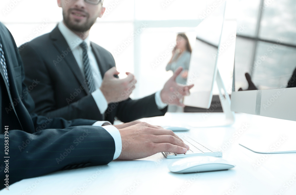 business colleagues sitting at their Desk business colleagues sitting at their Desk