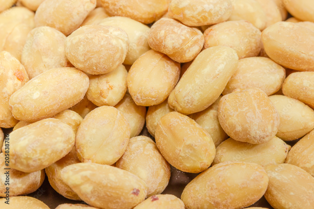 Background of roasted salted peanuts closeup at selective focus Background of roasted salted peanuts closeup at selective focus