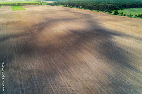 Aerial view of the arable field in spring. Rural landscape