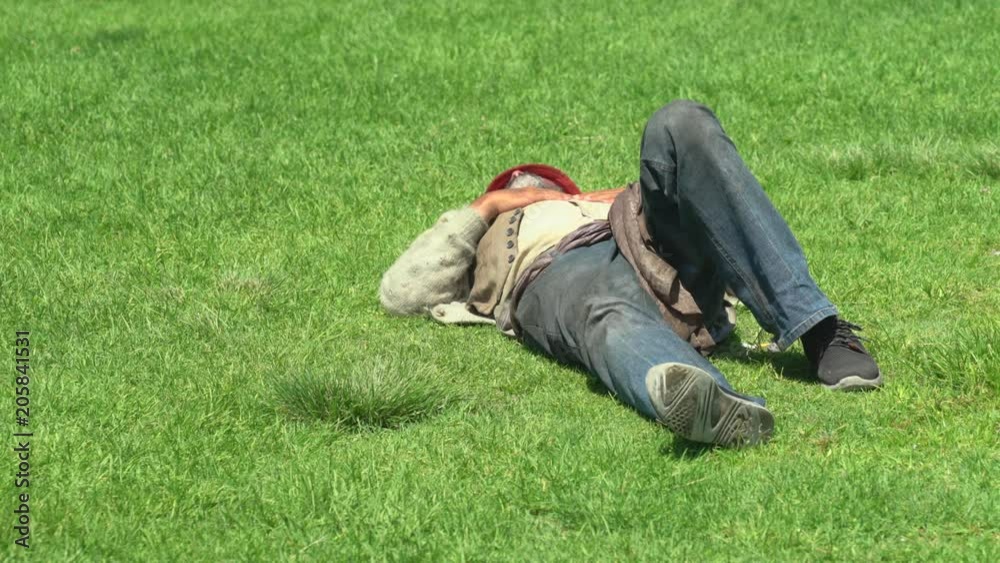 Homeless people lying on the lawn - August 2017: Los Angeles California, US Homeless people lying on the lawn - August 2017: Los Angeles California, US