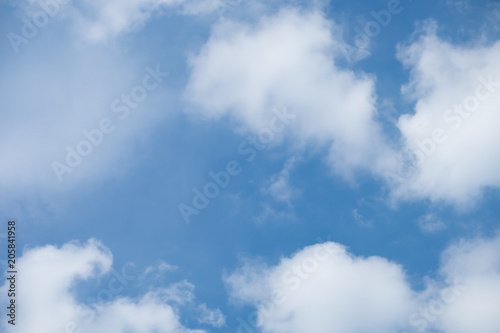 White Clouds on the bright sunny blue sky. Nature background.