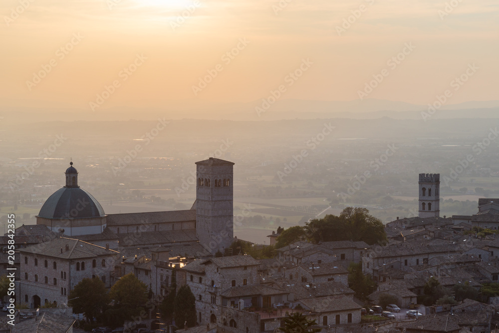 Beautiful and unusual view of Assisi town (Umbria, Italy) at sun